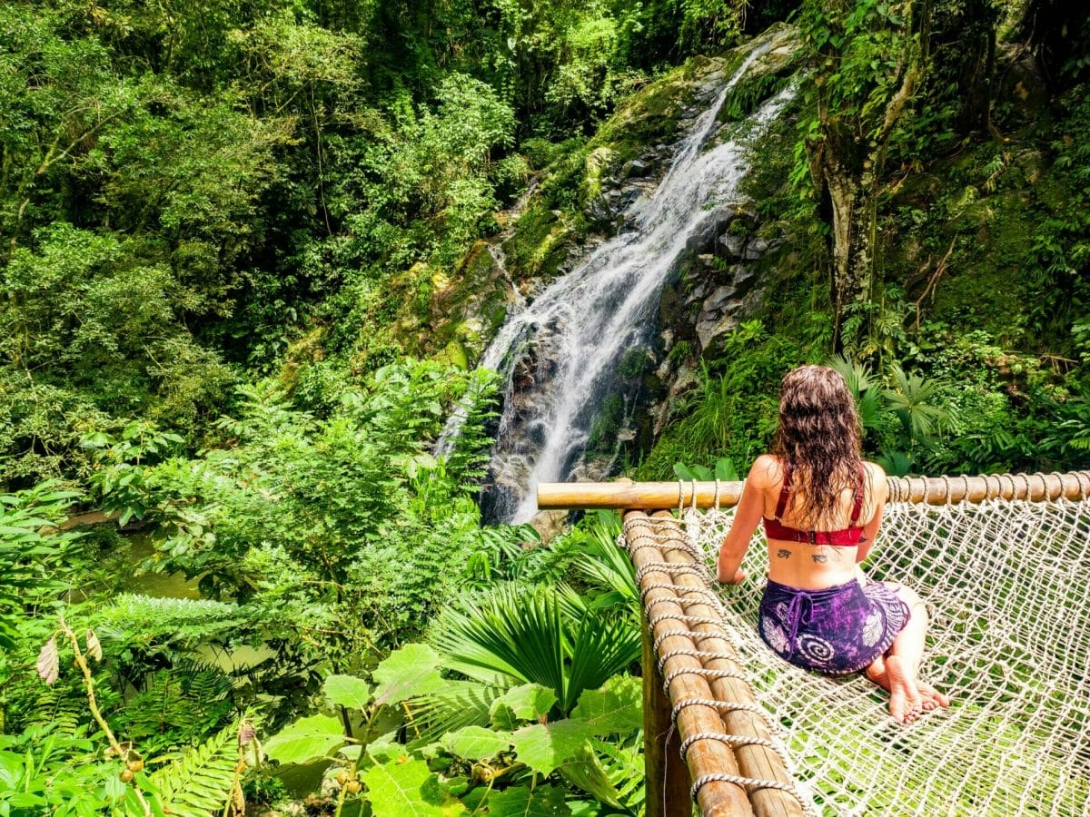 Girl sitting on hammock by Marinka Waterfall Minca Colombia
